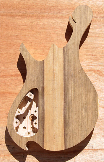 Custom bass body with black limba top, ash core