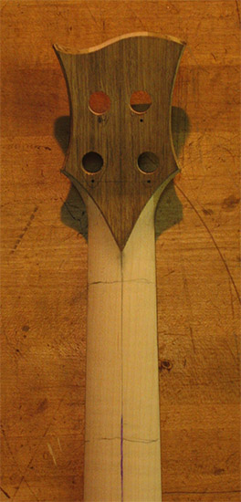 Black limba veneer on a carved bass headstock