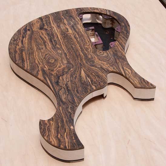 Custom bass guitar with Xylem style scroll, maple body