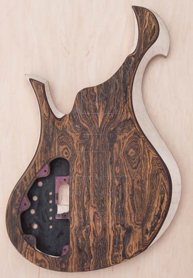 Hand-carved bass guitar body with Xylem scroll