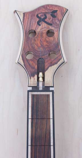 Cocobolo headstock on a custom bass with ebony inlay