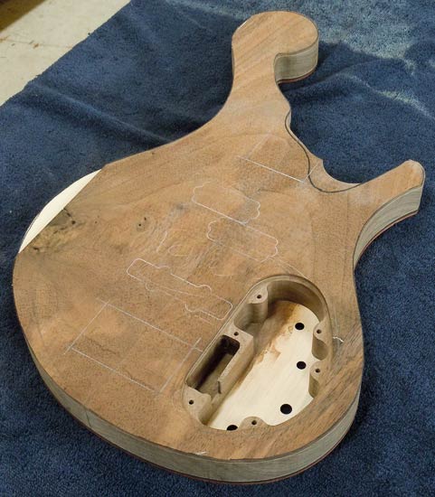 Peruvian walnut top with maple accent on a custom bass body