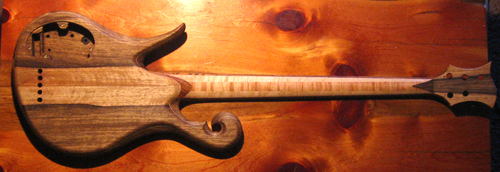 Entire custom bass guitar from the back with matching black limba book matches on the body and headstock