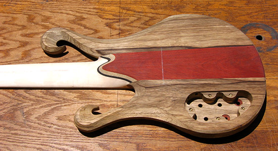 6 string bass with carved scrolls, bloodwood accent; back