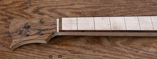 Custom bass neck with bocote binding and headstock cap