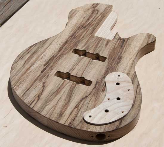 Ash and black limba bass guitar body with ash control cover