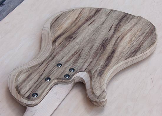 Bolt-on neck of a custom bass guitar, limba/ash body