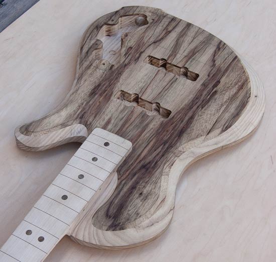 Whale-back bass guitar with ash/limba body, maple neck