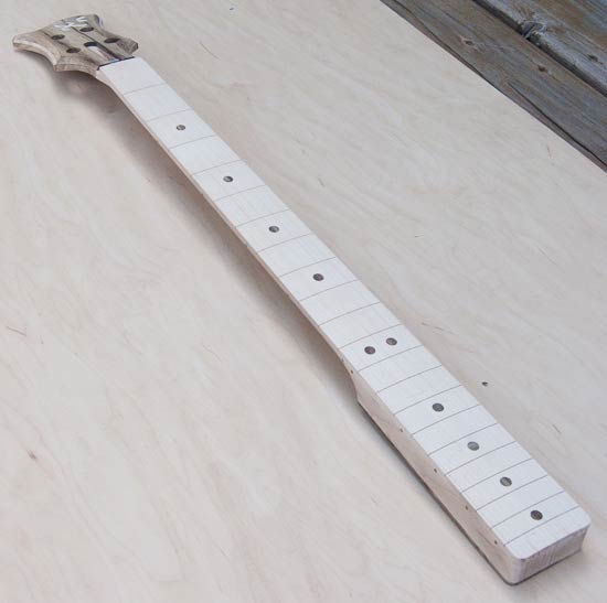 Custom bass neck made of maple and black limba