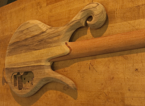 Scroll and cocobolo neck shim of a Xylem bass