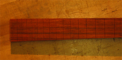 Slotted cocobolo fretboard of a 4 string bass