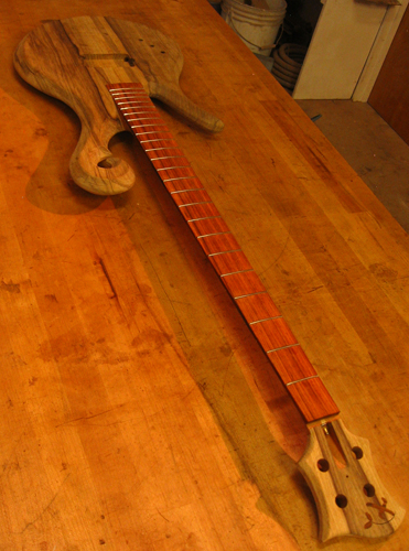 Xylem lefty custom bass guitar with black limba headstock and fretted cocobolo fretboard