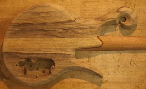 Back of a custom bass with limba body and exotic scroll