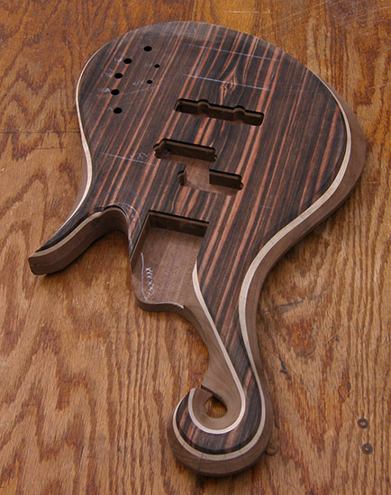 Custom bass body with macassar ebony top, maple accent