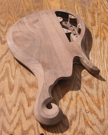 Black walnut bass body with exotic scroll, after carving