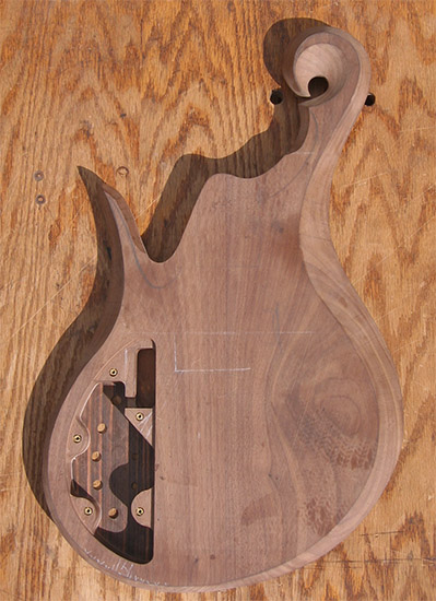 Custom bass body with black walnut exotic scroll