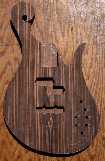 Exotic scroll on a black walnut bass body