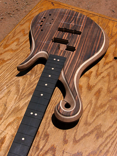 4 string bass with maple fretboard markers and exotic scroll