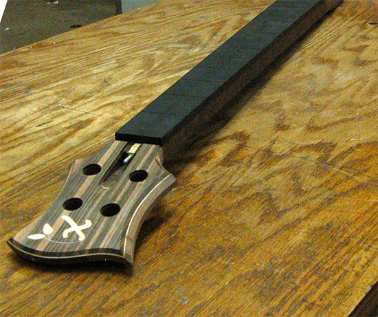 Custom bass neck with Xylem logo and ebony fretboard