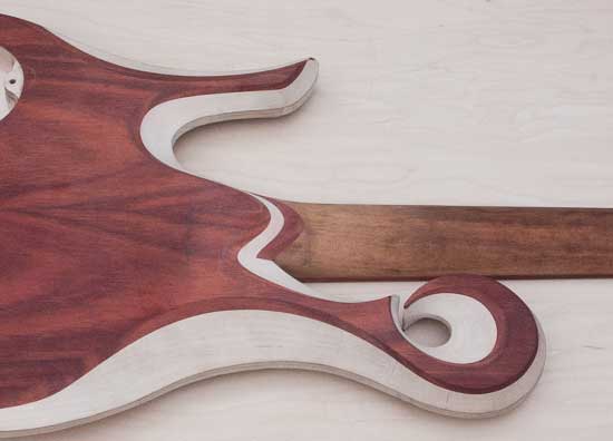 Carved neck heel of a custom bass guitar