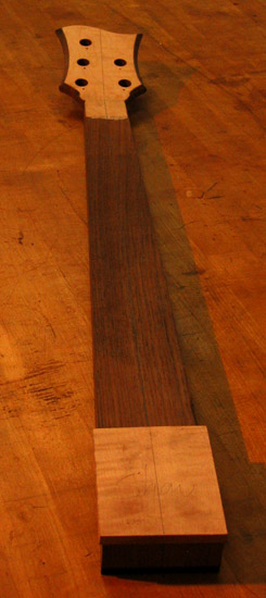 Curly maple neck shim on a black walnut bass guitar neck
