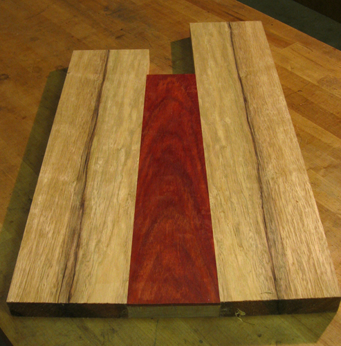 Back of a black limba and bloodwood bass body