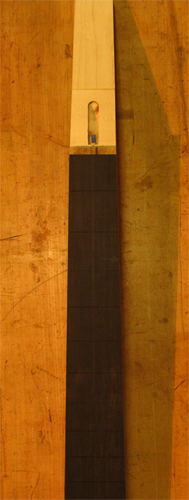 Ebony fretboard and maple core of a bass neck
