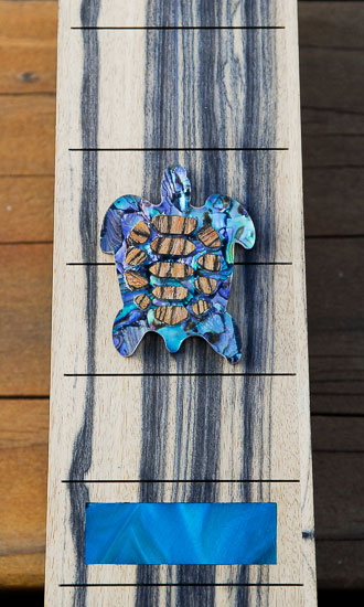 Volute of a four-string custom bass neck with Peruvian walnut veneer