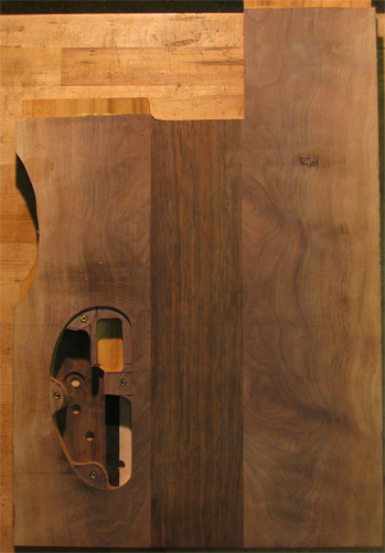 Xylem 5 string bass guitar body blank from the back with book matched black walnut top wood and control cavity