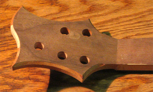 Black walnut veneer on the back of the custom bass guitar's headstock