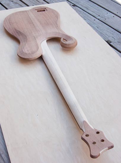 Carved neck heel of a maple/mahogany custom bass