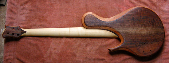 Single-cut custom bass with Claro walnut top, rock maple neck