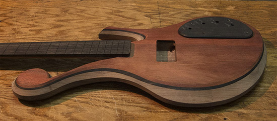 Short scale custom bass with ebony and bloodwood tops
