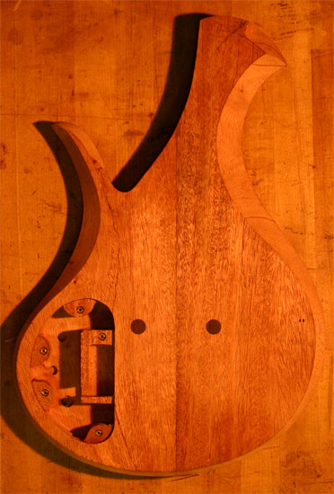 Back of a mahogany four string custom bass