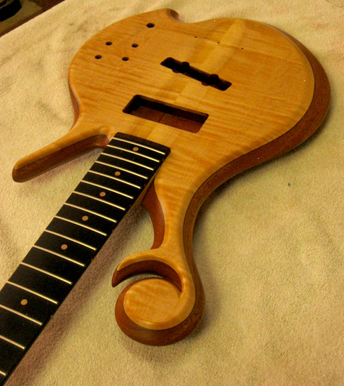 Xylem scroll, maple top and ebony fretboard on a custom bass