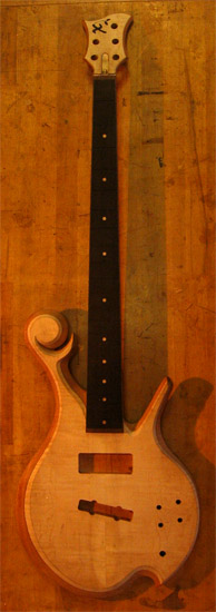 Custom bass with ebony fretboard and flamed maple top