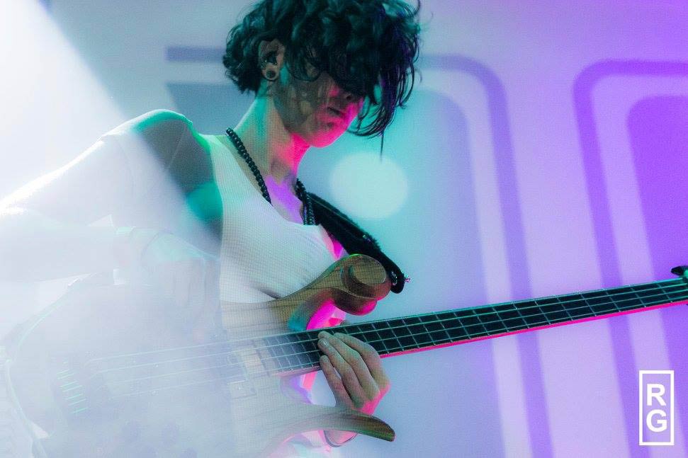 Xylem artist Dina Simone playing her Xylem bass guitar on stage
