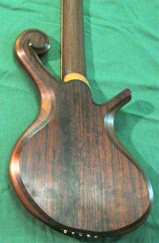The bass from the back with brass string retainer and bookmatched black walnut topwood