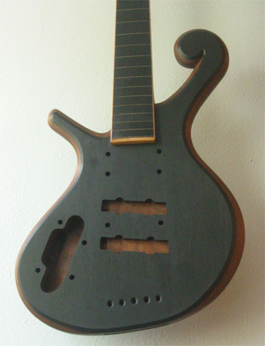 The ebony fretboard and topwood of the bass' body with rock maple binding and fret markers