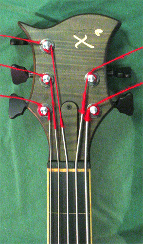 The front of the bass' headstock with maple Xylem logo inlay