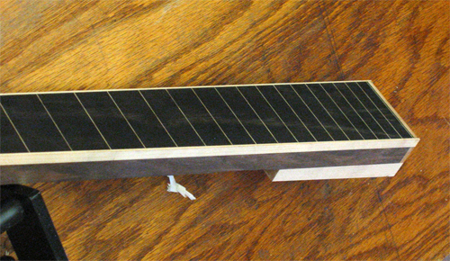 Maple neck shim from the side of the neck