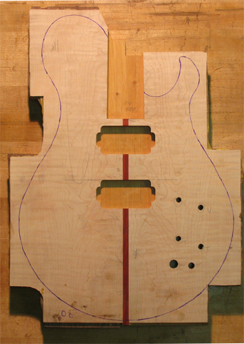 Body blank of a Xylem custom guitar with flamed maple top and bloodwood center strip