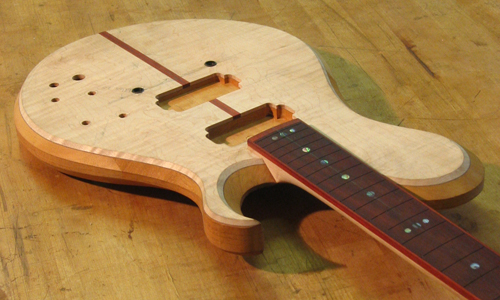 Lower and upper horns of a Xylem mahogany custom guitar