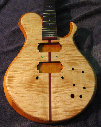 Custom guitar with flamed maple top, blood wood stripe and mahogany core