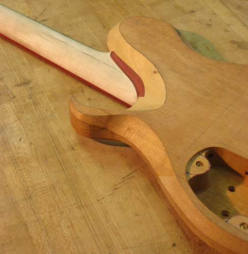 Neck joint of a Xylem mahogany guitar with bloodwood neck shim