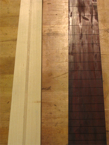 The custom guitar's neck blank and slotted fingerboard just before they are glued together