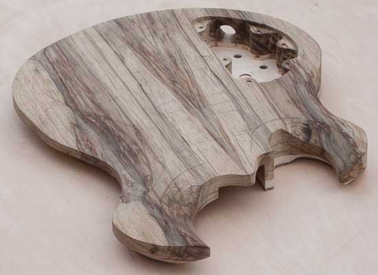 Custom guitar body made of black limba with maple accents
