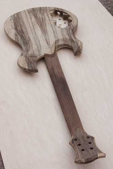 Back of a custom guitar with walnut neck, black limba body