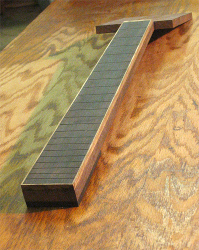 Black limba-bound ebony fretboard on the custom guitar's black walnut neck