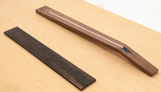 Peruvian walnut and ebony fretboard during a guitar build
